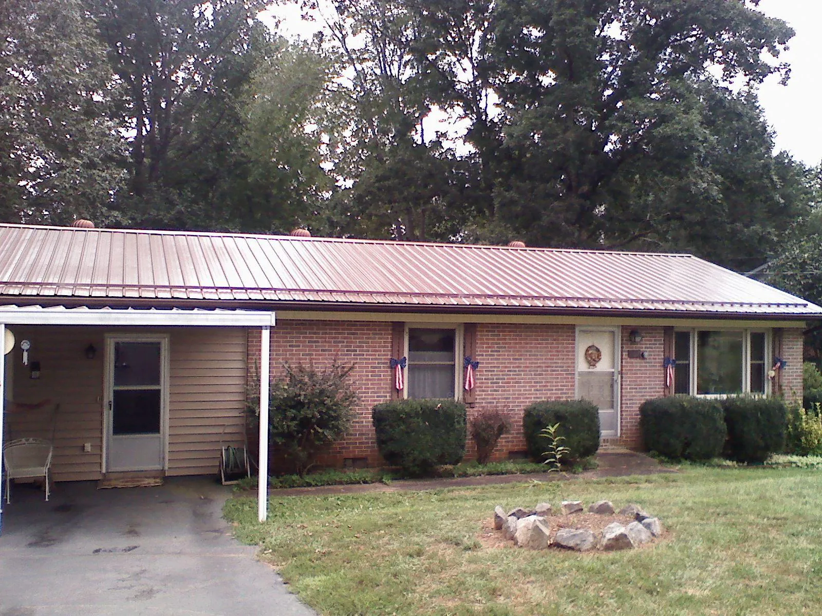 Bronze metal roof and carport on a brick ranch home — Roof Repair work by our crew in West Barnstable